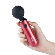 A red wand vibrator with a black ball head held in a hand.