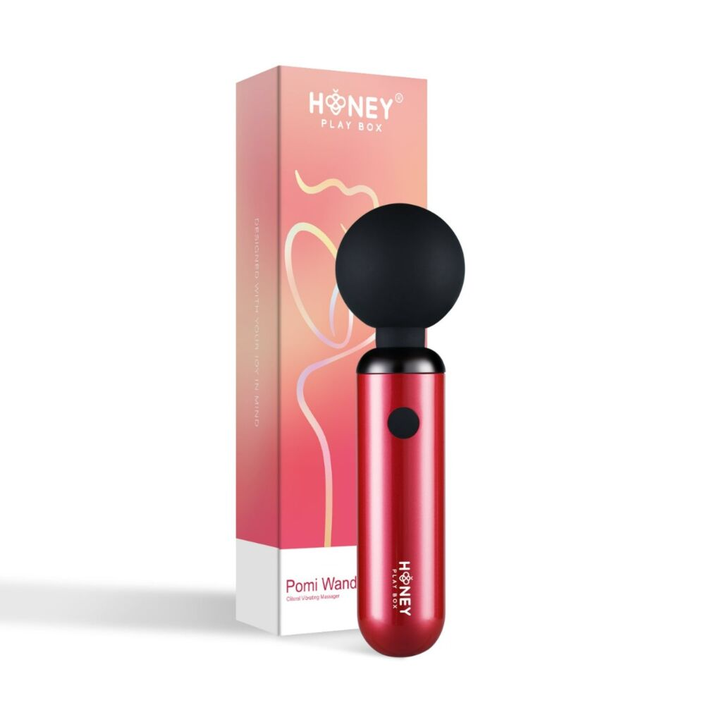 Red wand vibrator with a black ball head next to its pink and orange box.