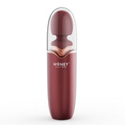 A maroon and clear Stormi Heating Wand with Honey Play Box branding.