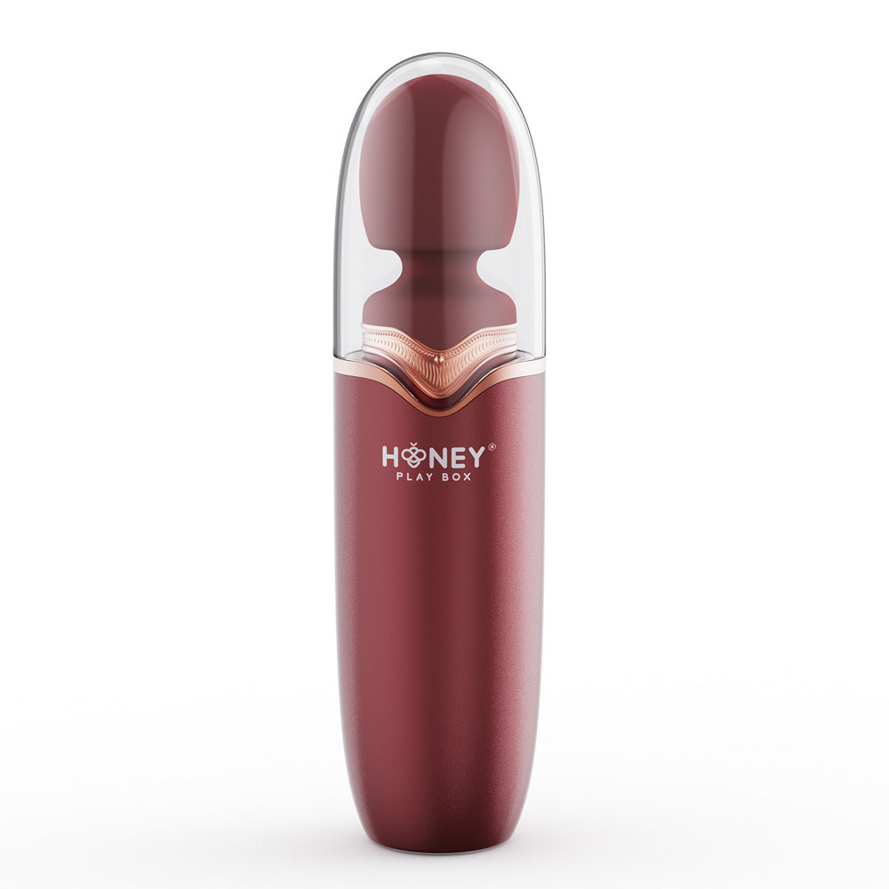 A maroon and clear Stormi Heating Wand with Honey Play Box branding.