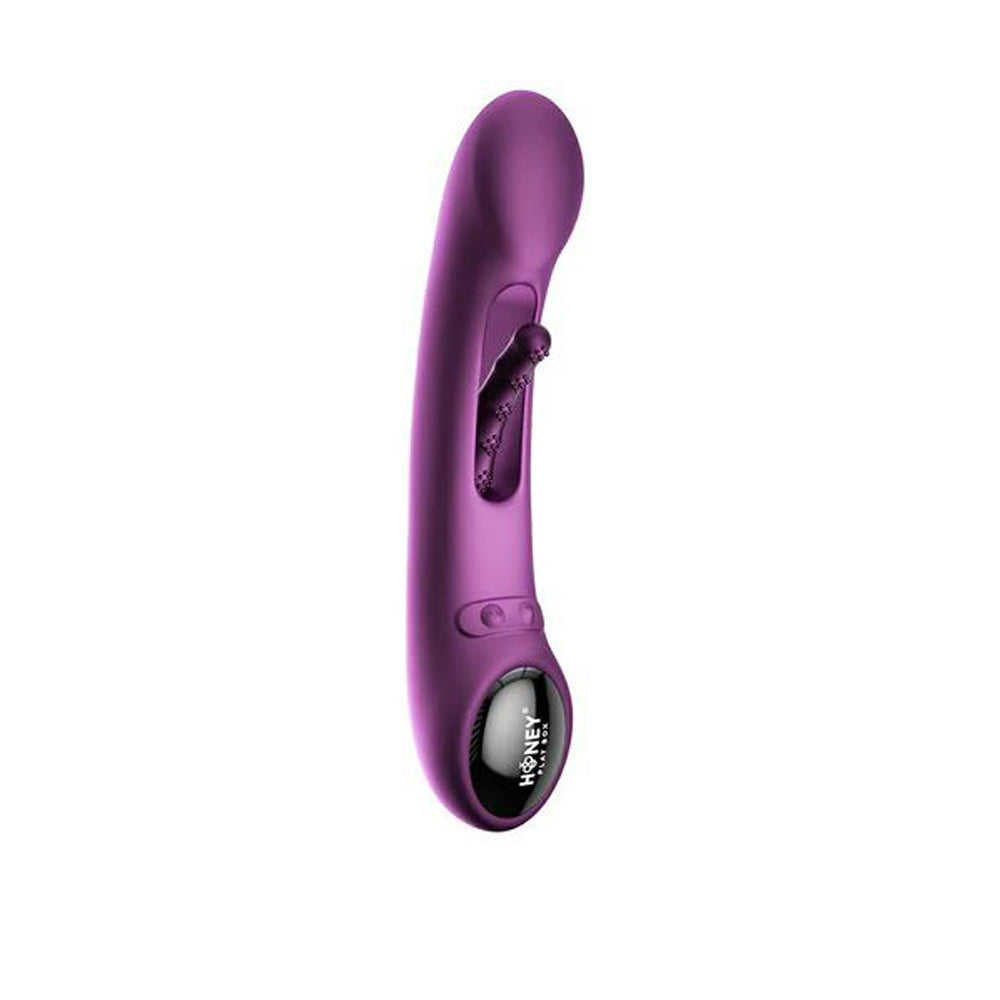 Purple G-spot tapping massager with a textured tip and a control panel.