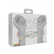 Edible candy handcuffs with multi-flavored candy beads connecting two wrists.
