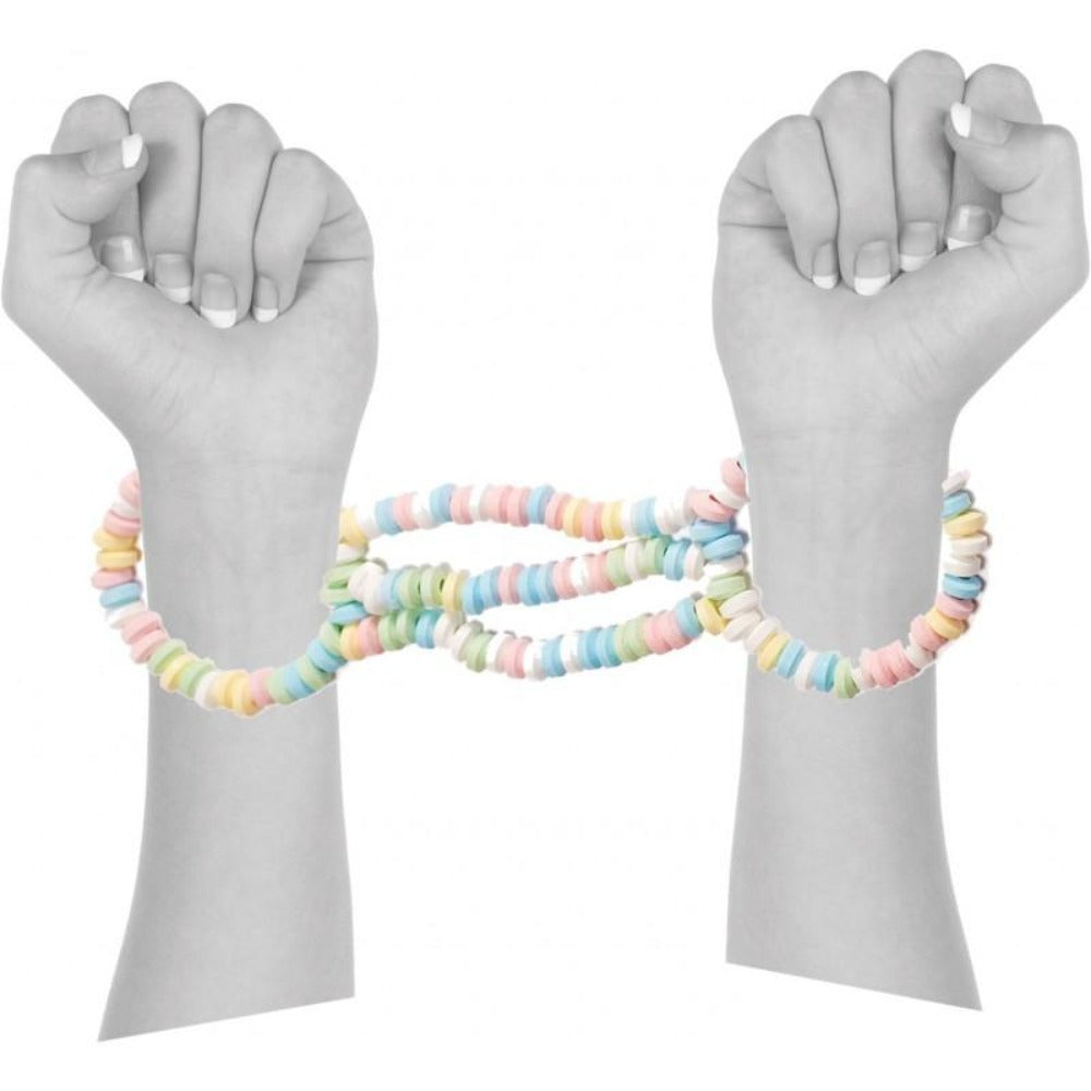 Edible candy handcuffs in pastel colors connect two wrists.
