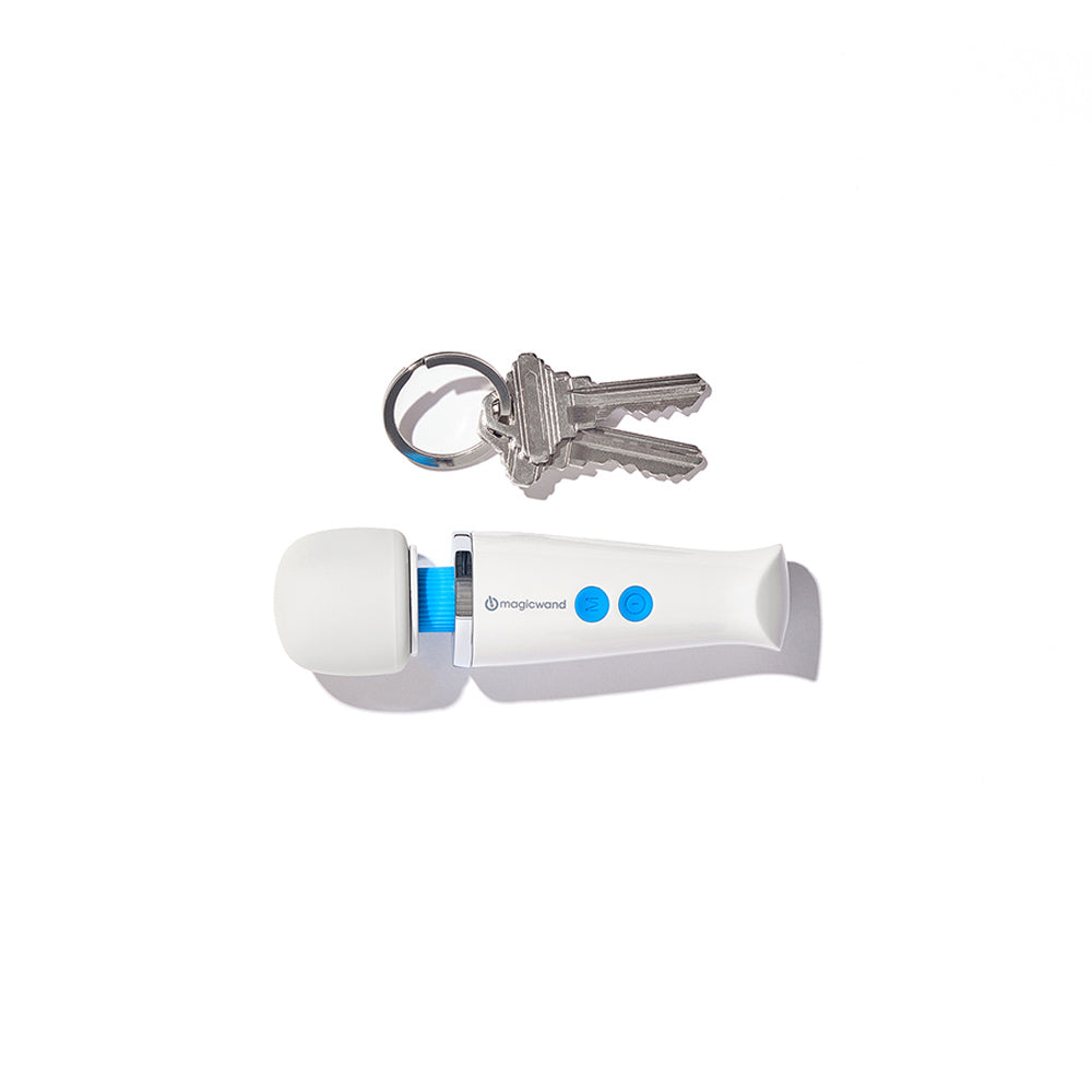 A white Magic Wand massager with blue accents and two keys on a keyring.