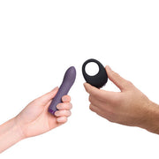 Two hands hold a purple vibrator and a black ring vibrator.