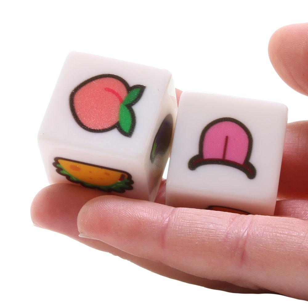 Two white dice with emoji faces, one showing a peach and the other a tongue.