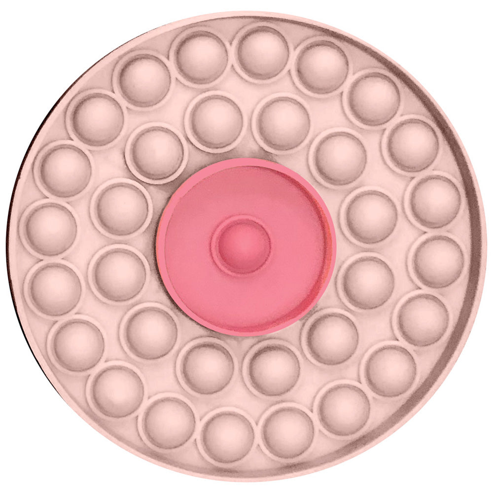 Round pink pop-it fidget toy with a central pink disc.