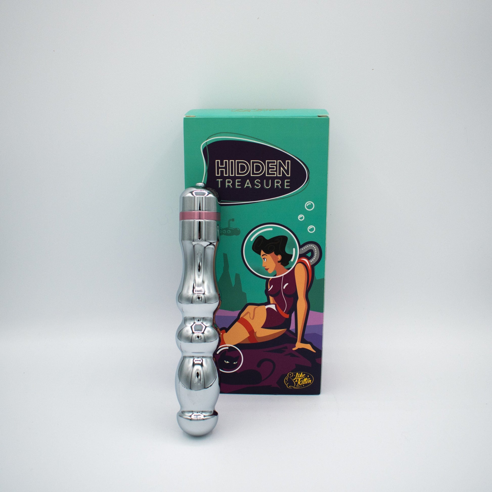 A silver metal G-spot vibrator with pink accents next to its box.