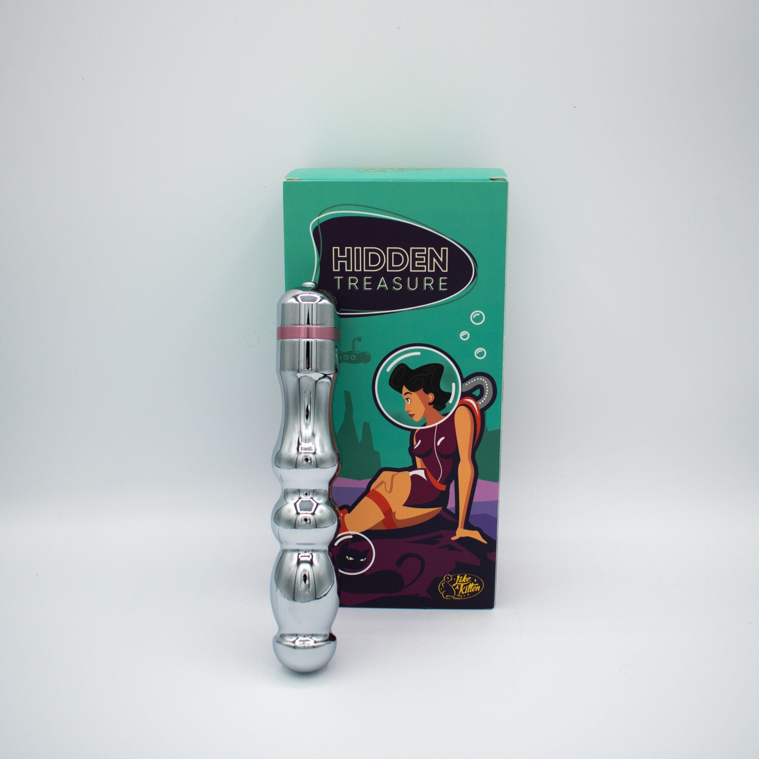A silver metal G-spot vibrator with pink accents next to its box.