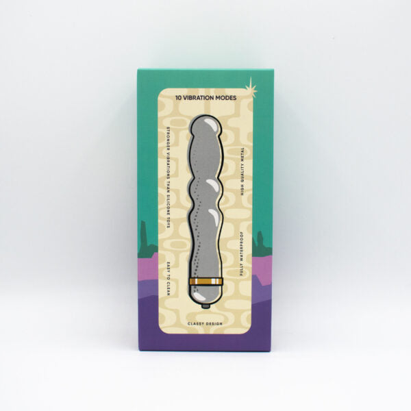A silver metal vibrator with a wavy design on a product box.