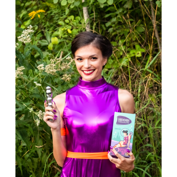 A woman holds a metallic vibrator and a box for the Hidden Treasure vibrator.