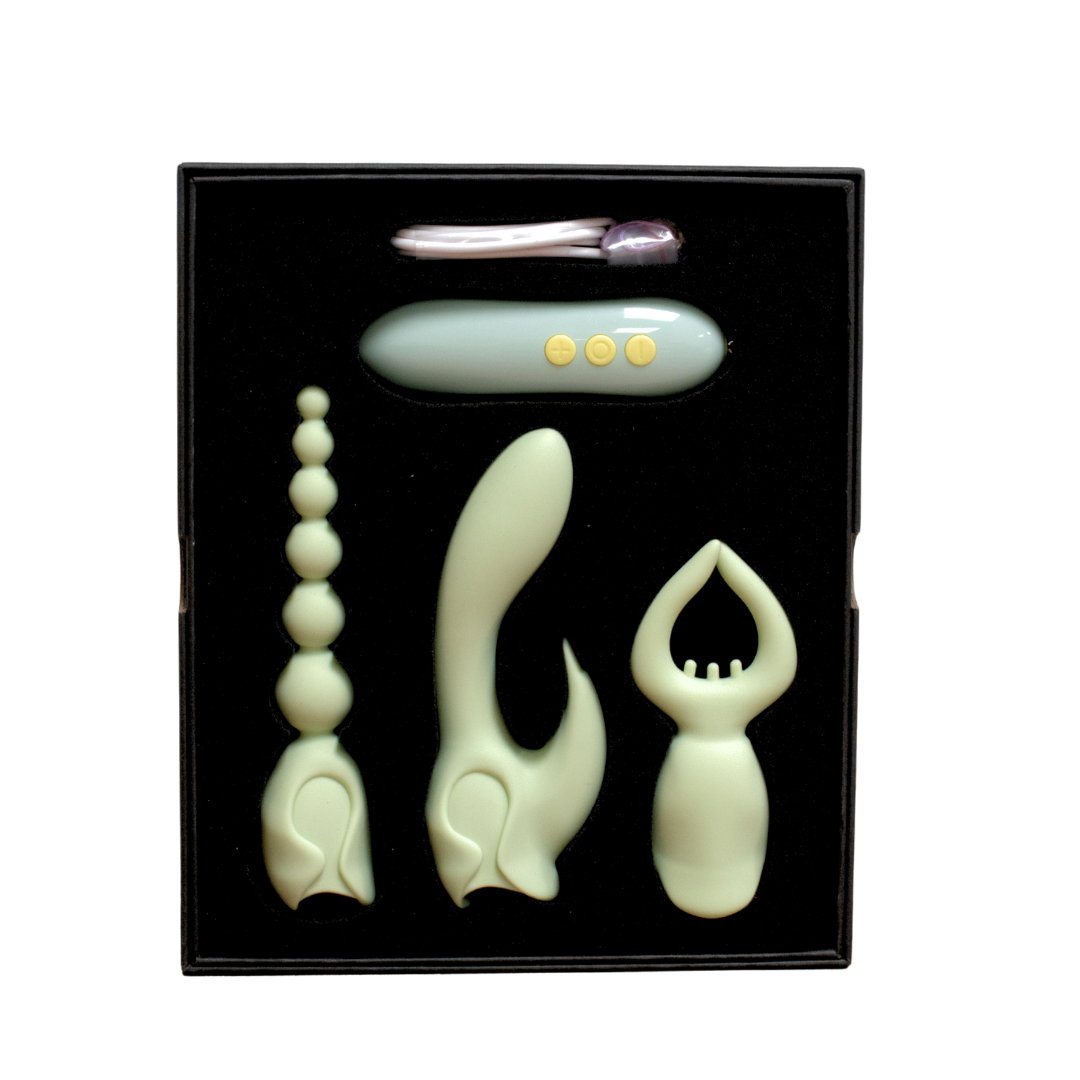 A light green silicone vibrator kit with four attachments in a black box.
