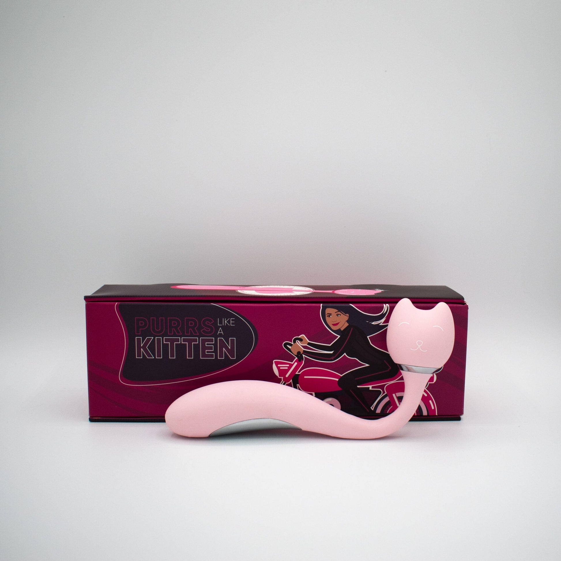 Pink silicone wand vibrator with a cat-shaped head and a box featuring a woman on a motorcycle.