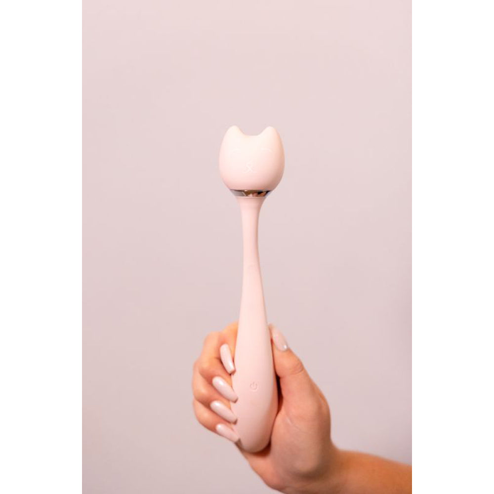 A pink cat-shaped wand vibrator held in a hand.