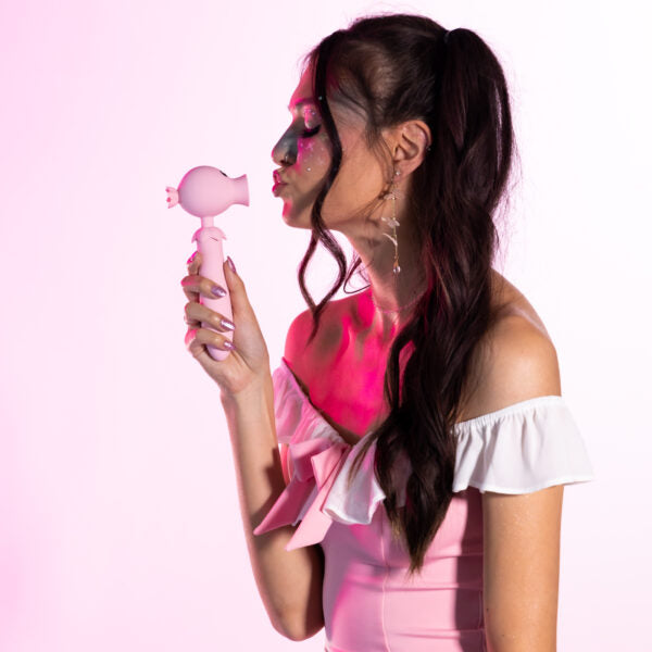 Pink tongue flicker vibrator with glitter makeup.