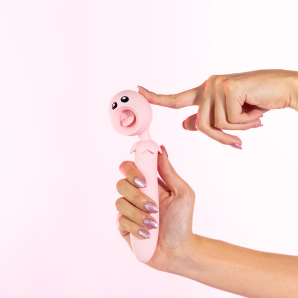 Pink tongue flicker toy held by two hands with glittery nails.