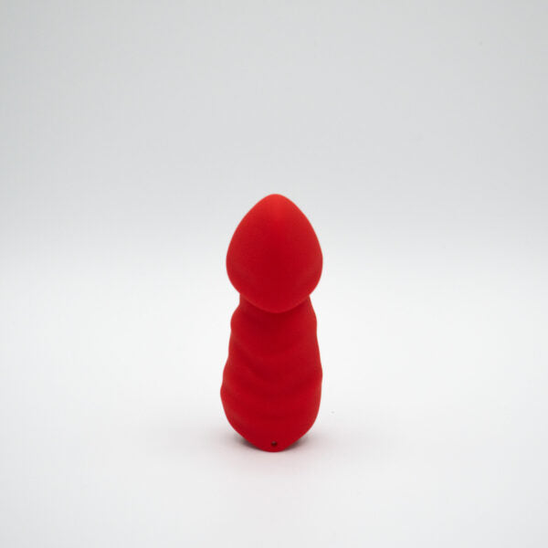 A small, red, bullet-shaped vibrator made of silicone.