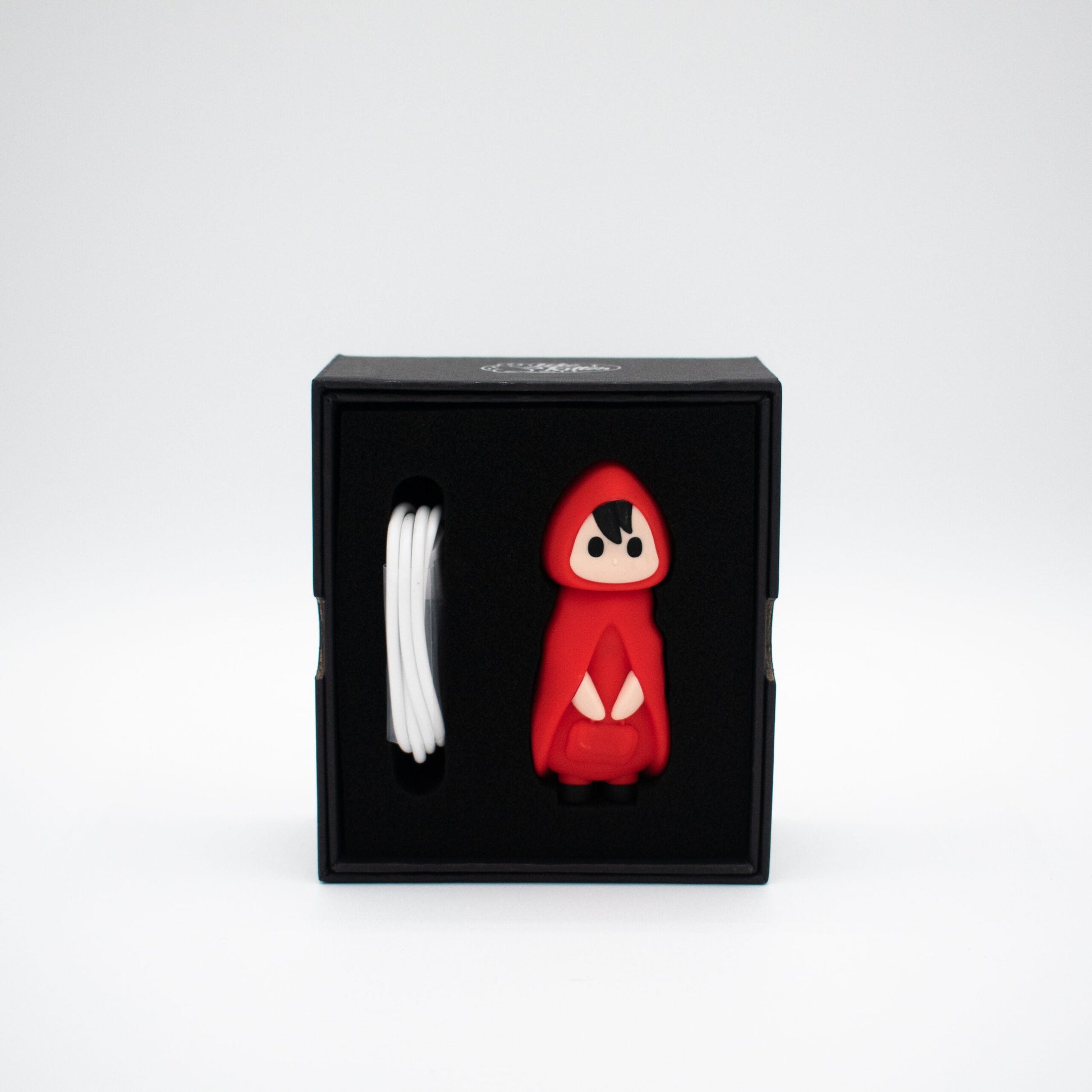 Little Red waterproof silicone bullet vibrator in a black box with a white charging cable.