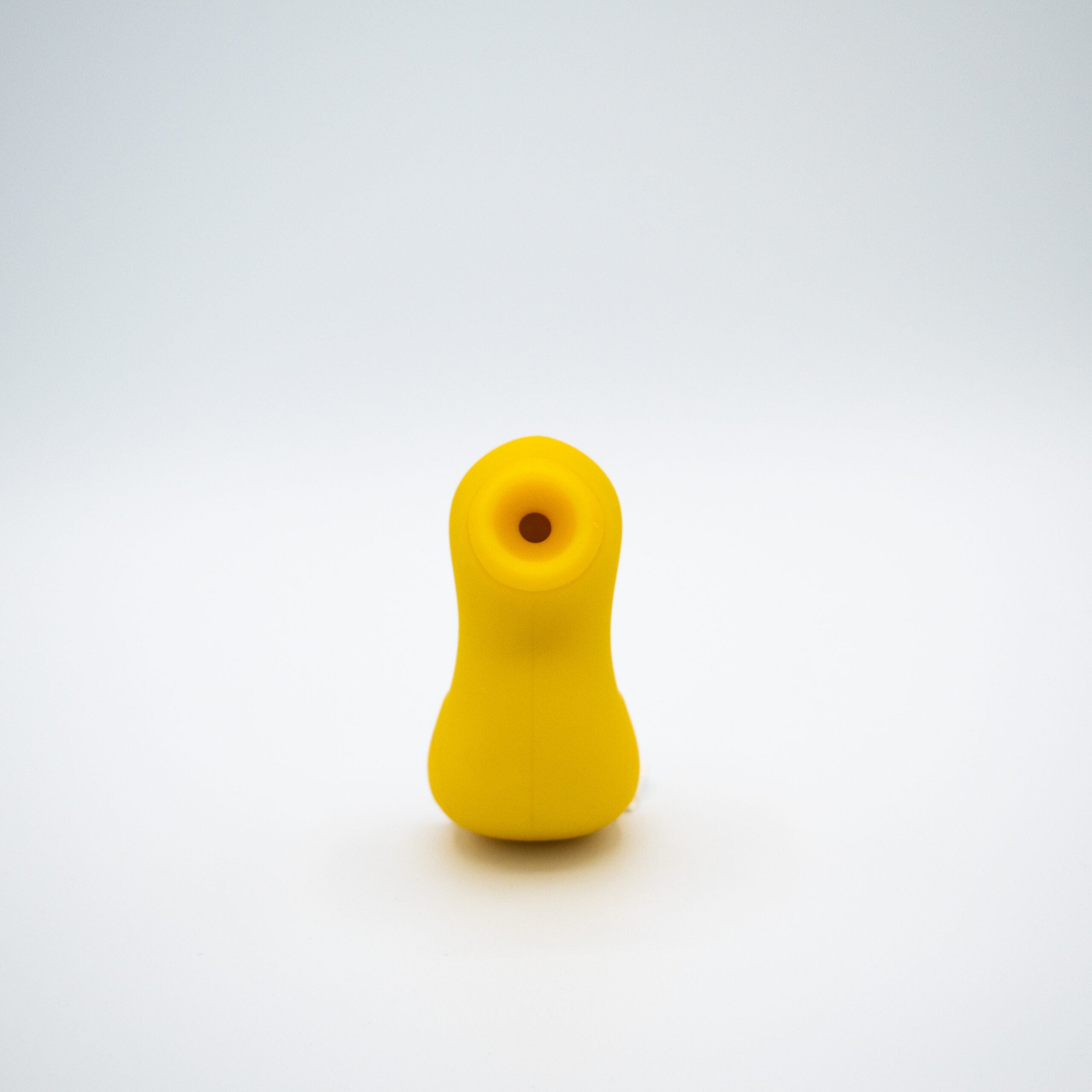 Yellow silicone duck-shaped stimulator with a suction opening.