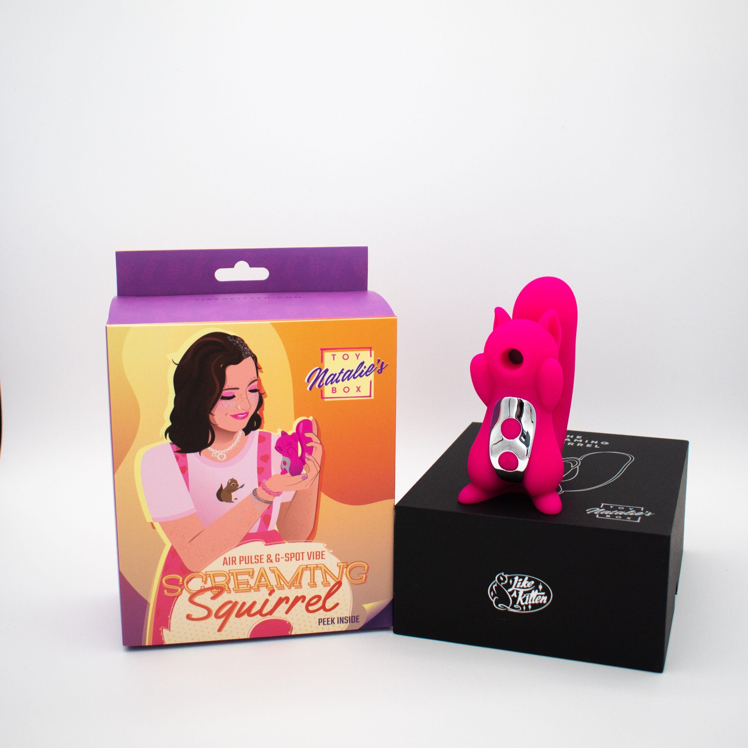 A pink squirrel-shaped vibrator sits next to its box, which features an illustration of a woman.