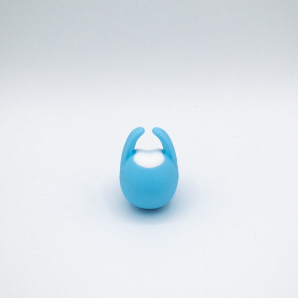 A blue finger vibrator with a white center on a white background.