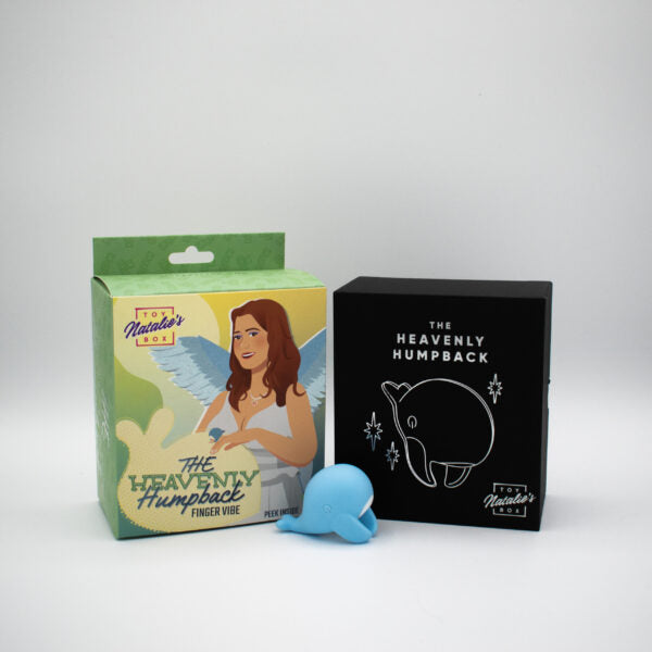 A blue whale-shaped finger vibrator next to its packaging.