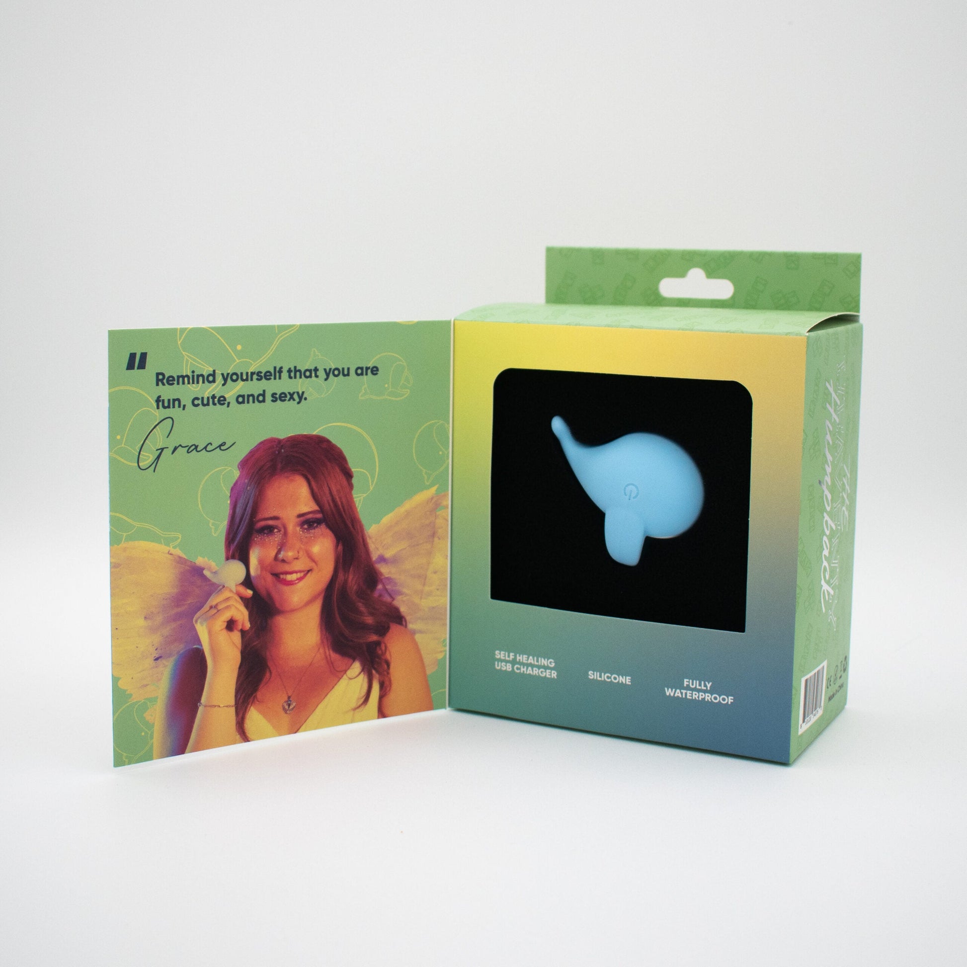 Heavenly Humpback finger vibrator in whale shape, with card featuring a woman.