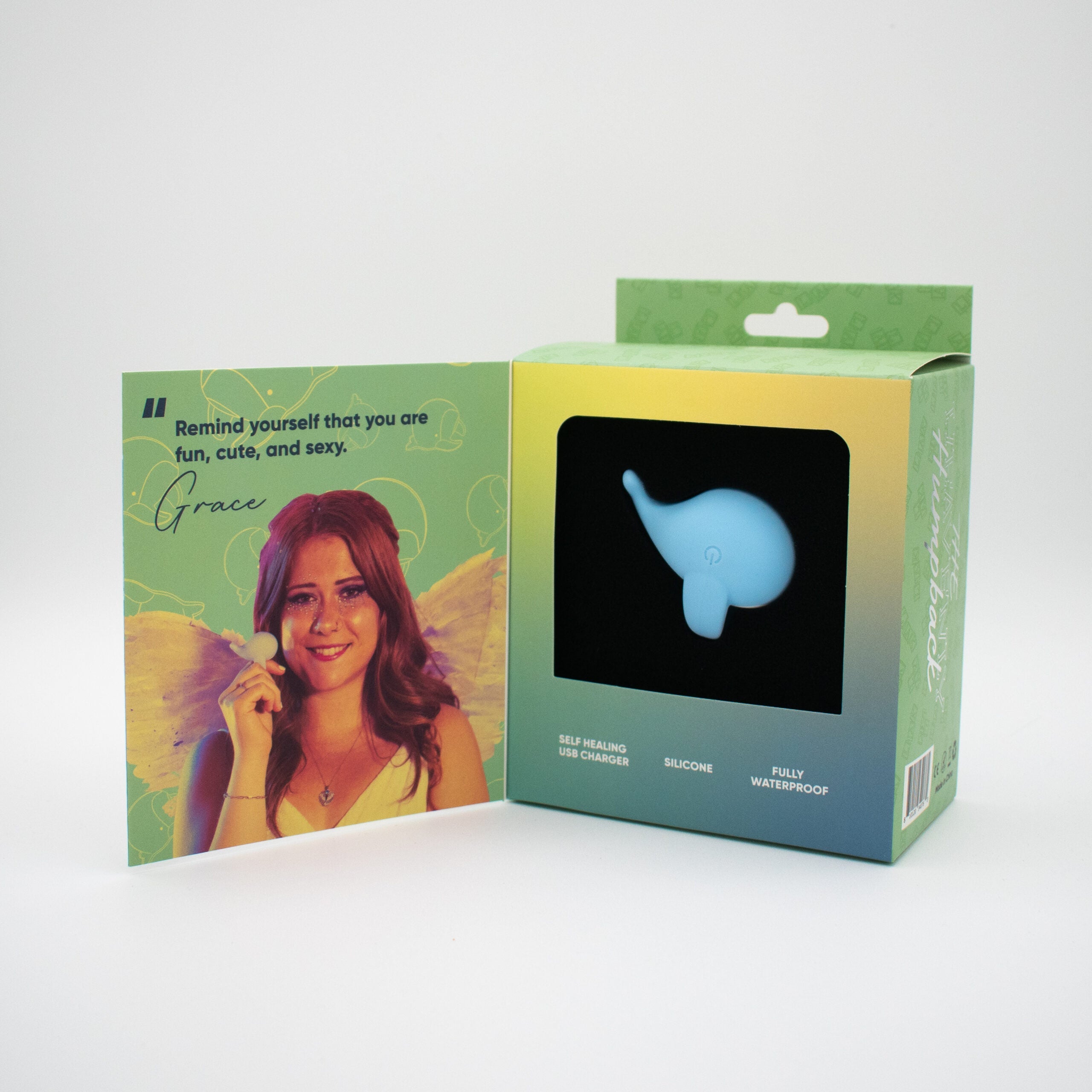Heavenly Humpback finger vibrator in whale shape, with card featuring a woman.