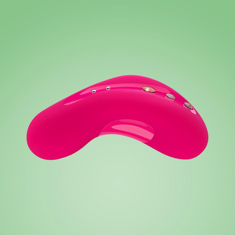 A pink curved vibrating massager with three buttons on a light green background.