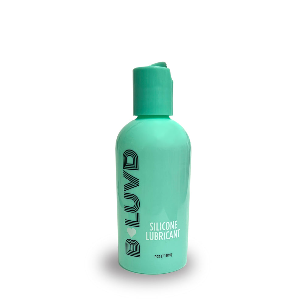 A teal bottle of B-Luvd silicone lubricant with a flip-top cap.