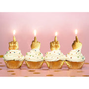 Gold glitter middle finger birthday candles on cupcakes.