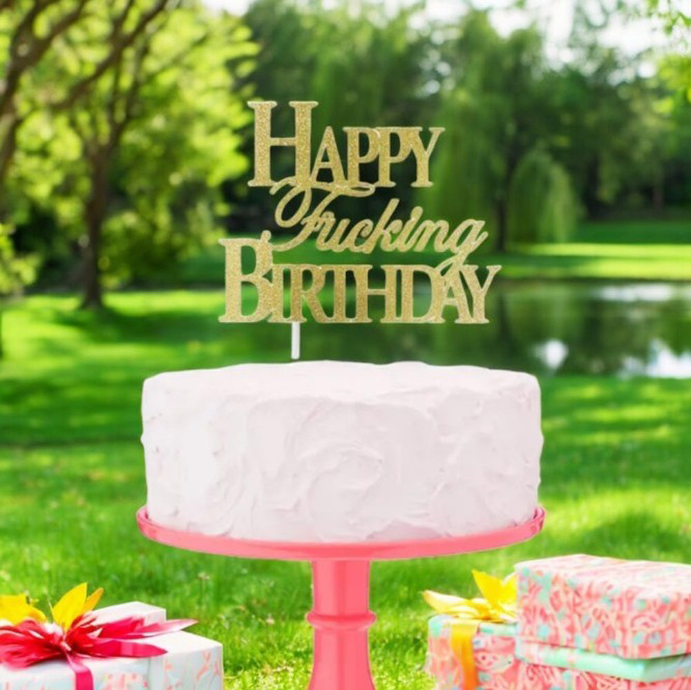 Gold glitter cake topper with "Happy Fucking Birthday" text.