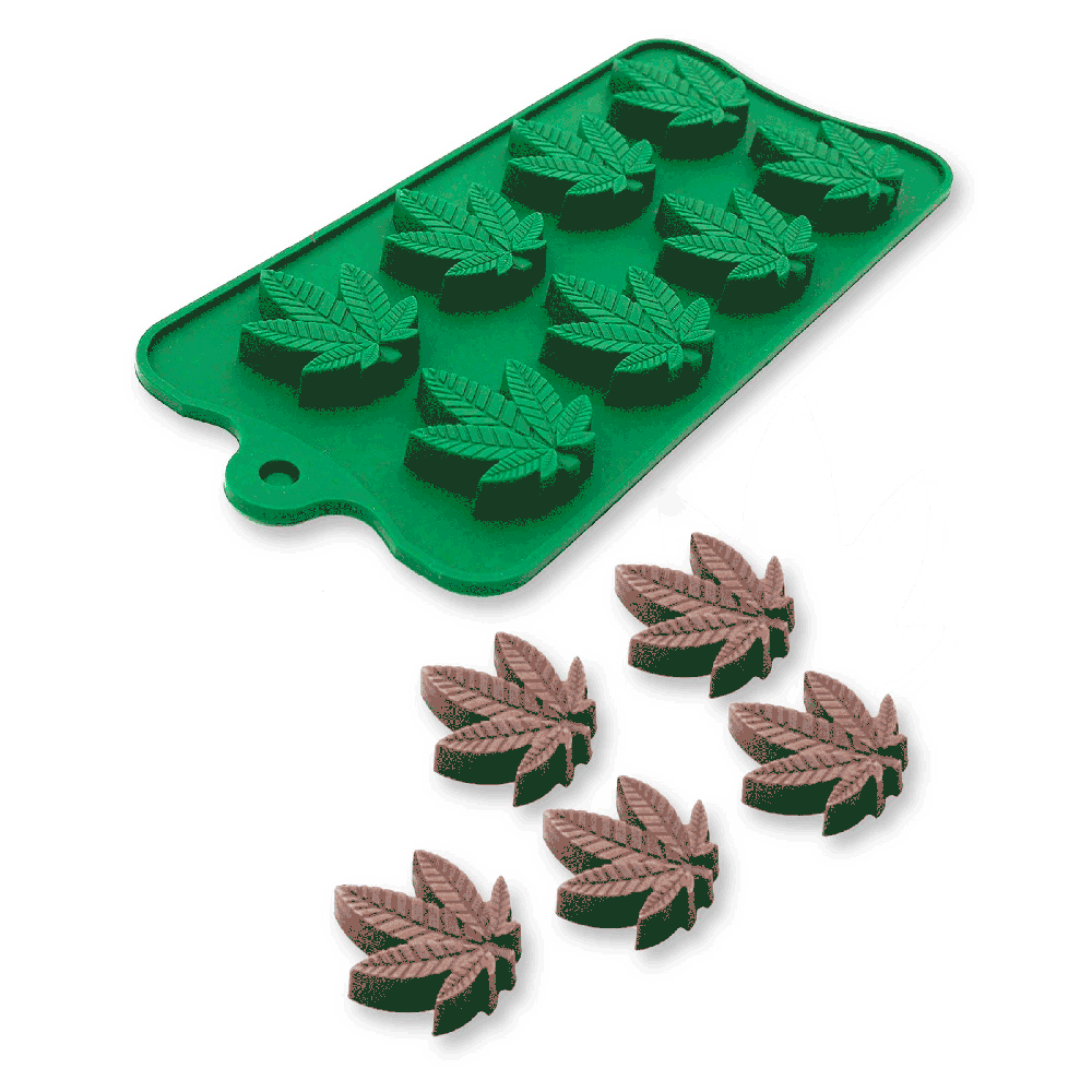 Green silicone mold with 11 cannabis leaf cavities and six brown cannabis leaf candies.