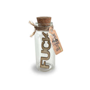 Glass jar with cork stopper, wooden letters spelling "FUCK" and a tag that reads "THE LAST FUCK I HAVE TO GIVE".