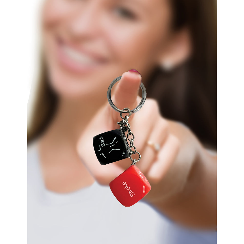 Keychain with two dice, one black with "Back" and one red with "Stroke".