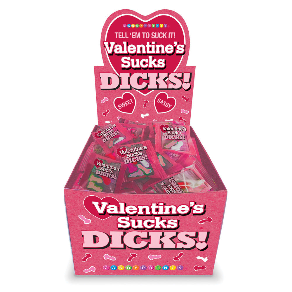 A pink display box filled with individually wrapped novelty candies that say "Valentine's Sucks Dicks".
