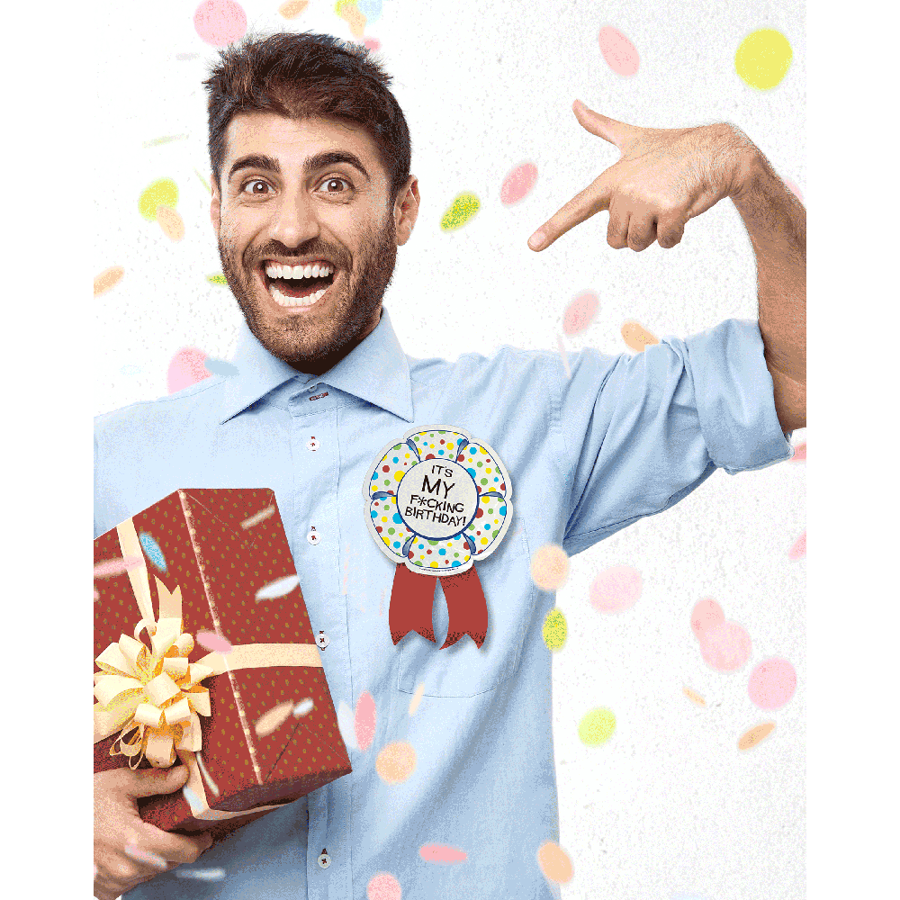 Man wearing a "It's My Fucking Birthday" ribbon and holding a gift.