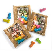 Novelty candy dicks in colorful bags and scattered on a white background.