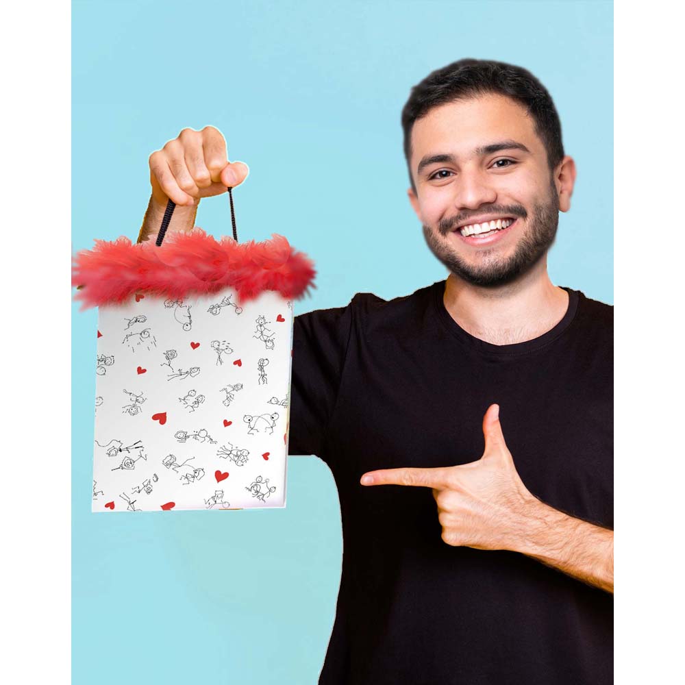 A gift bag with naughty stick figures and pink marabou fringe.