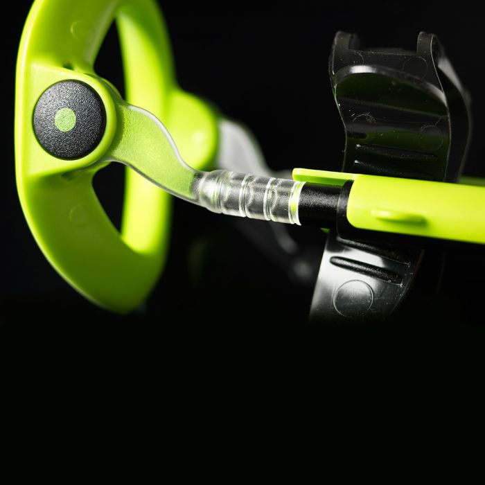 Close-up of a green and black penis extender with a clear tube.