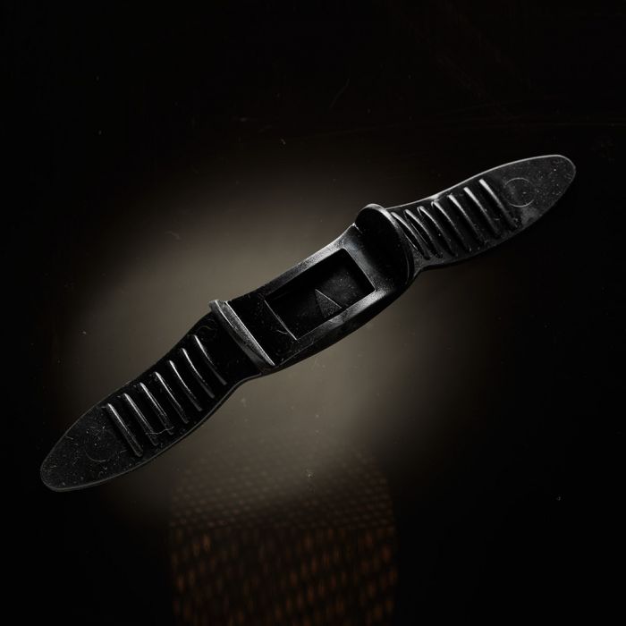 Black plastic penis extender with ribbed texture and a central rectangular opening.