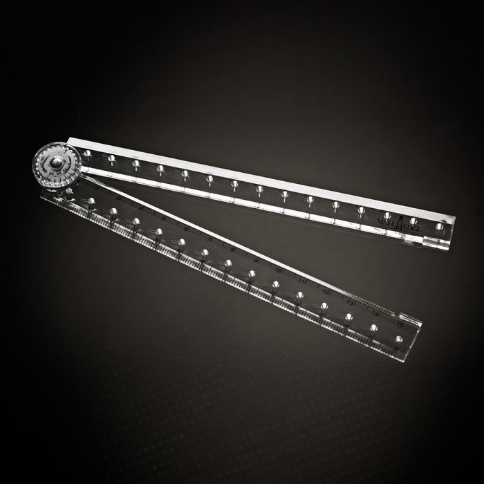 A clear, foldable ruler with measurement markings and a circular dial.