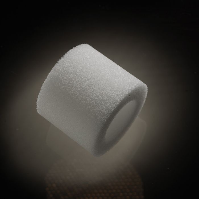 White foam cylinder with a hole in the center.