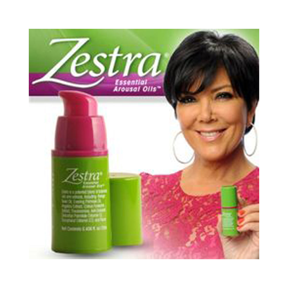 Zestra Essential Arousal Oil for women in a green bottle with a pink pump, next to a woman.