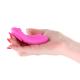 Magenta app-controlled rechargeable panty vibrator held in a hand.