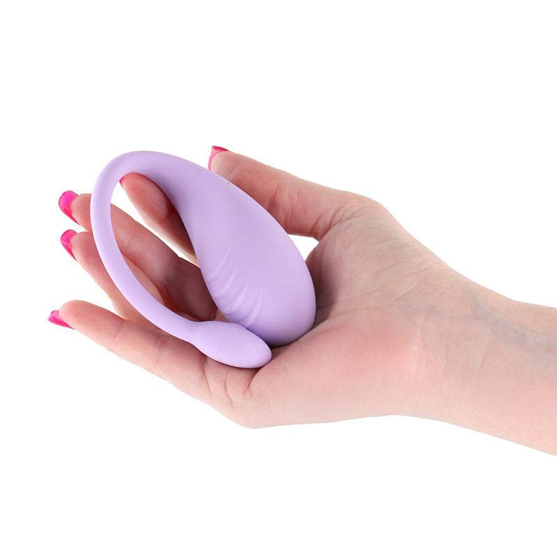 Lavender app-controlled rechargeable silicone vibe held in a hand.