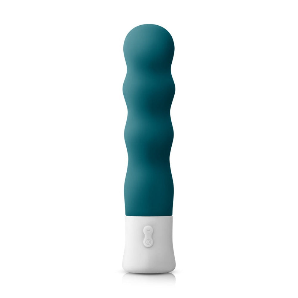 A dark teal silicone vibrator with a white base and wavy texture.