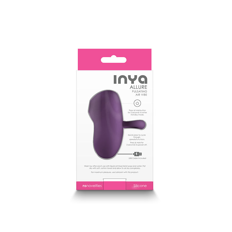 A dark purple silicone clitoral stimulator with instructions on its packaging.