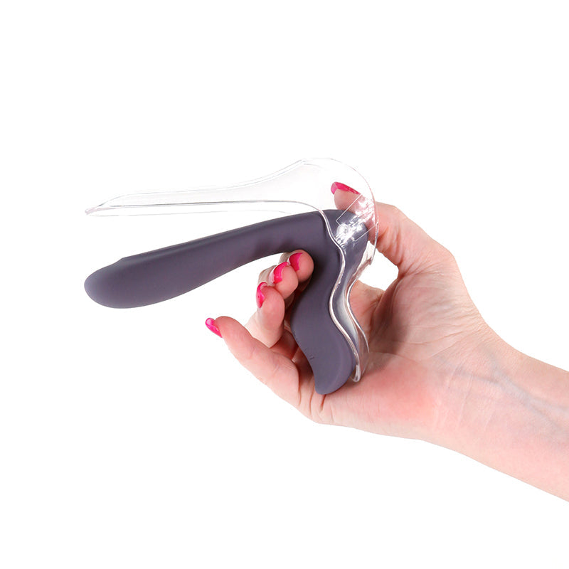 A hand holds a purple and clear vaginal dilator with an LED light.