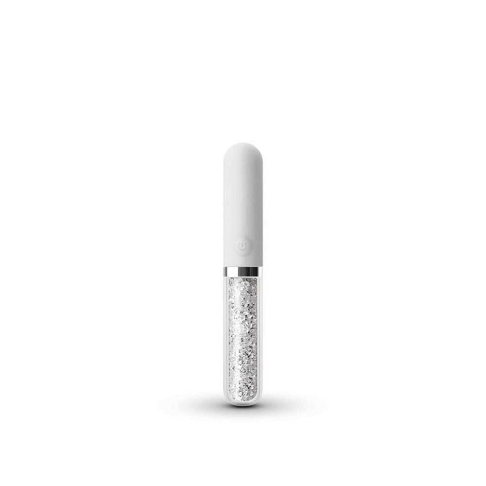 A white silicone massager with a crystal-filled glass base.